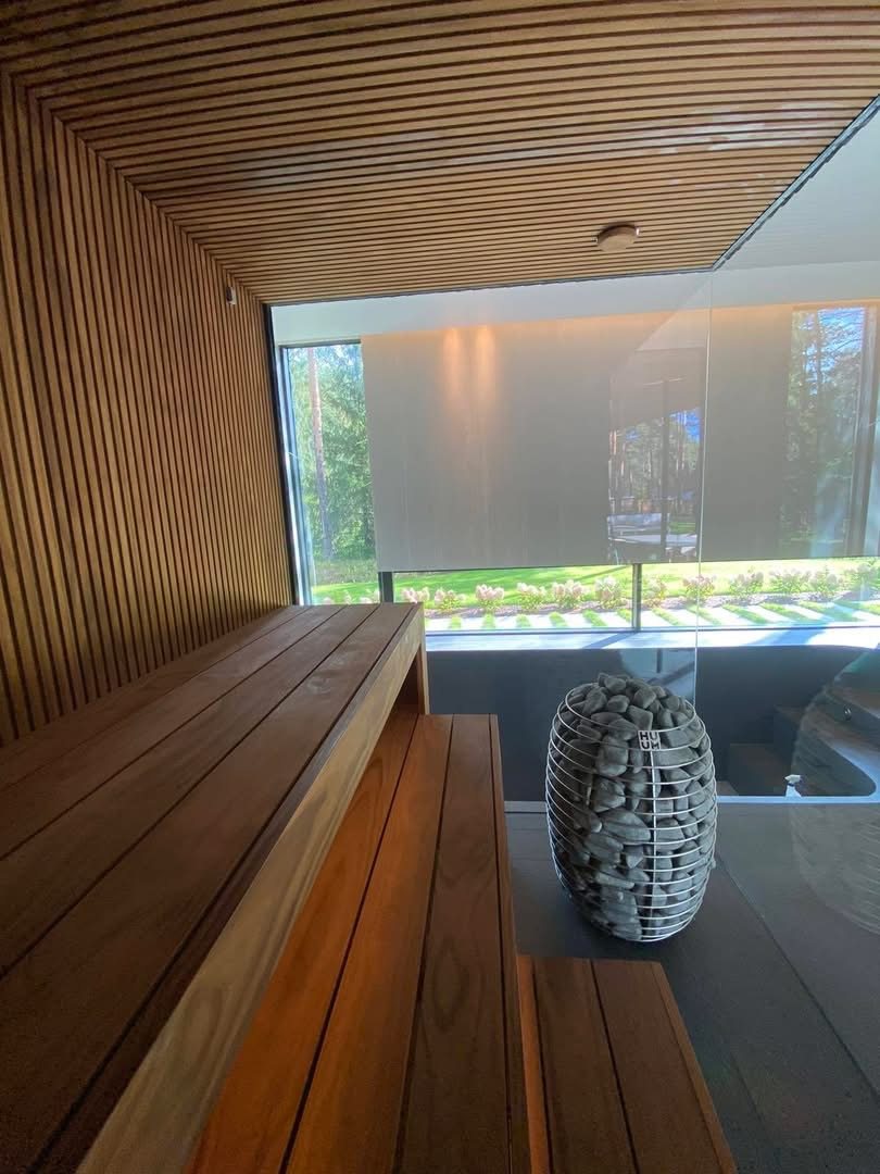 Modern sauna interior with a garden view, shared by Victoria E.